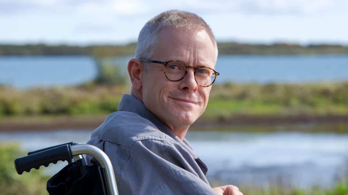 Homme souriant en fauteuil